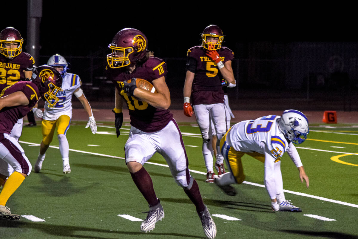 Trojans Randal Murray (10) runs the ball against Moapa Valley on Thursday, Oct. 10, 2024, in Pa ...