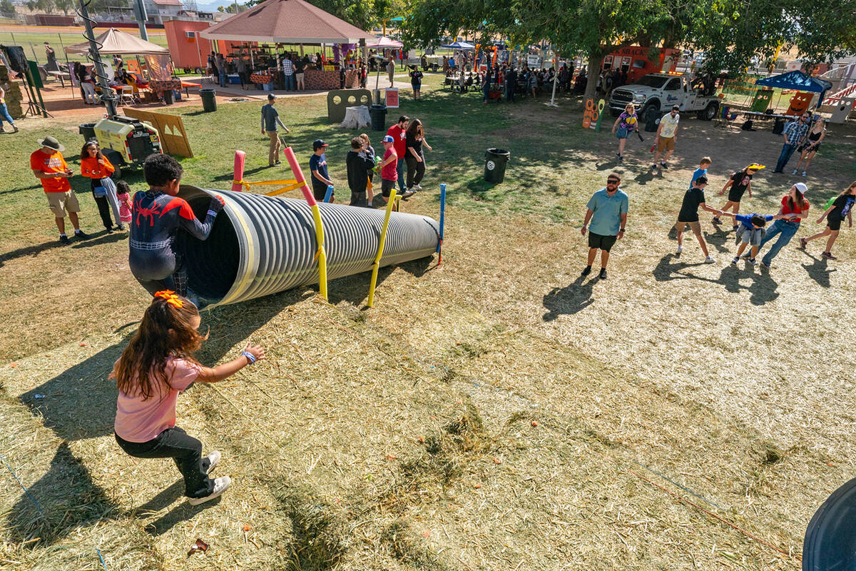 John Clausen/Pahrump Valley Times From atop the hay pyramid, children could sweep down the slid ...