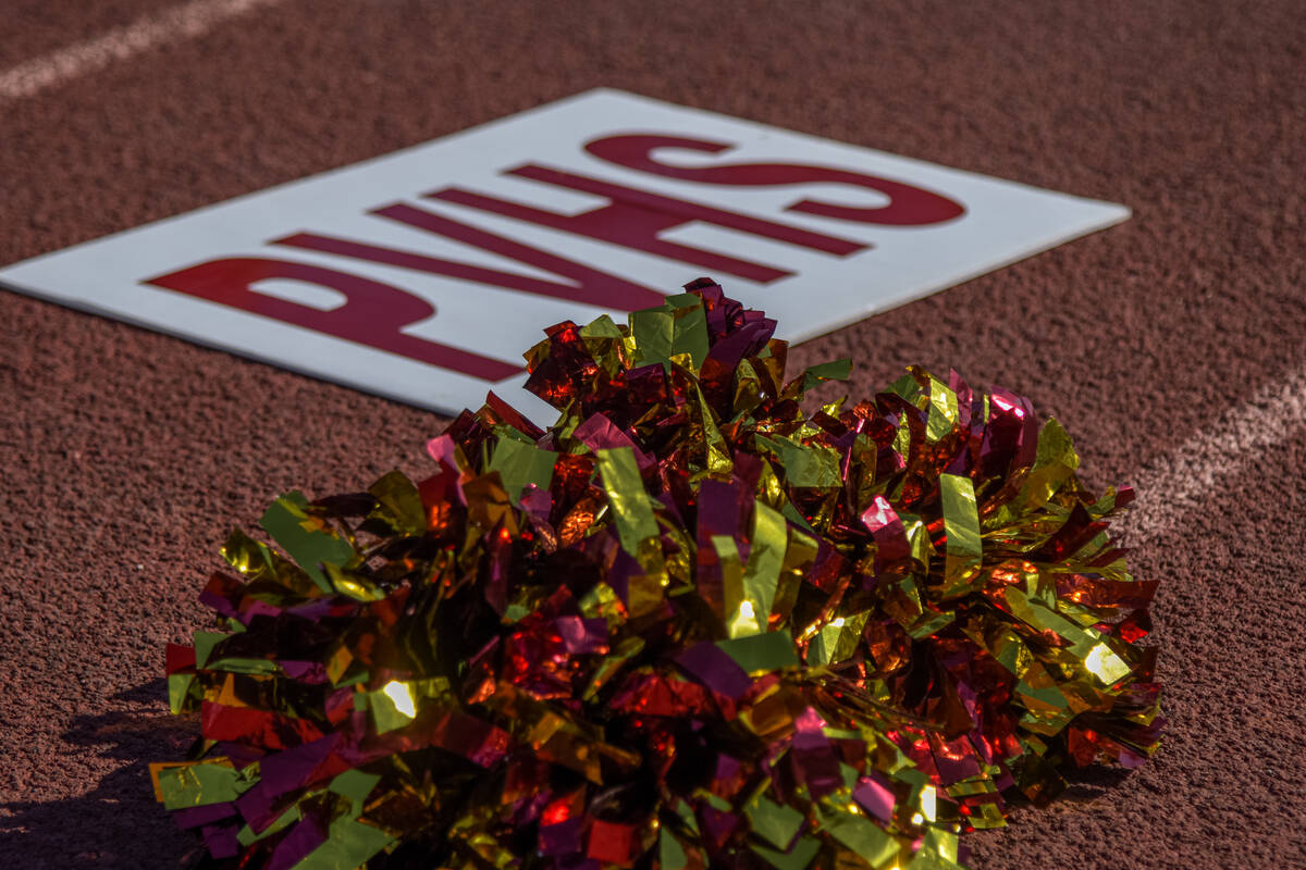 Some Trojans cheerleaders' maroon and gold pom-poms lay on the track of the Pahrump Valley foot ...