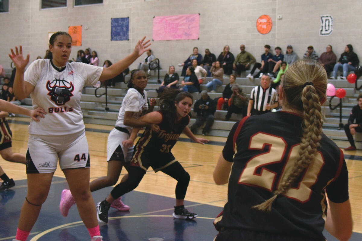 Paris Coleman (33) (center) is trying to catch a pass from Avery (20) (right) as Sports Leaders ...