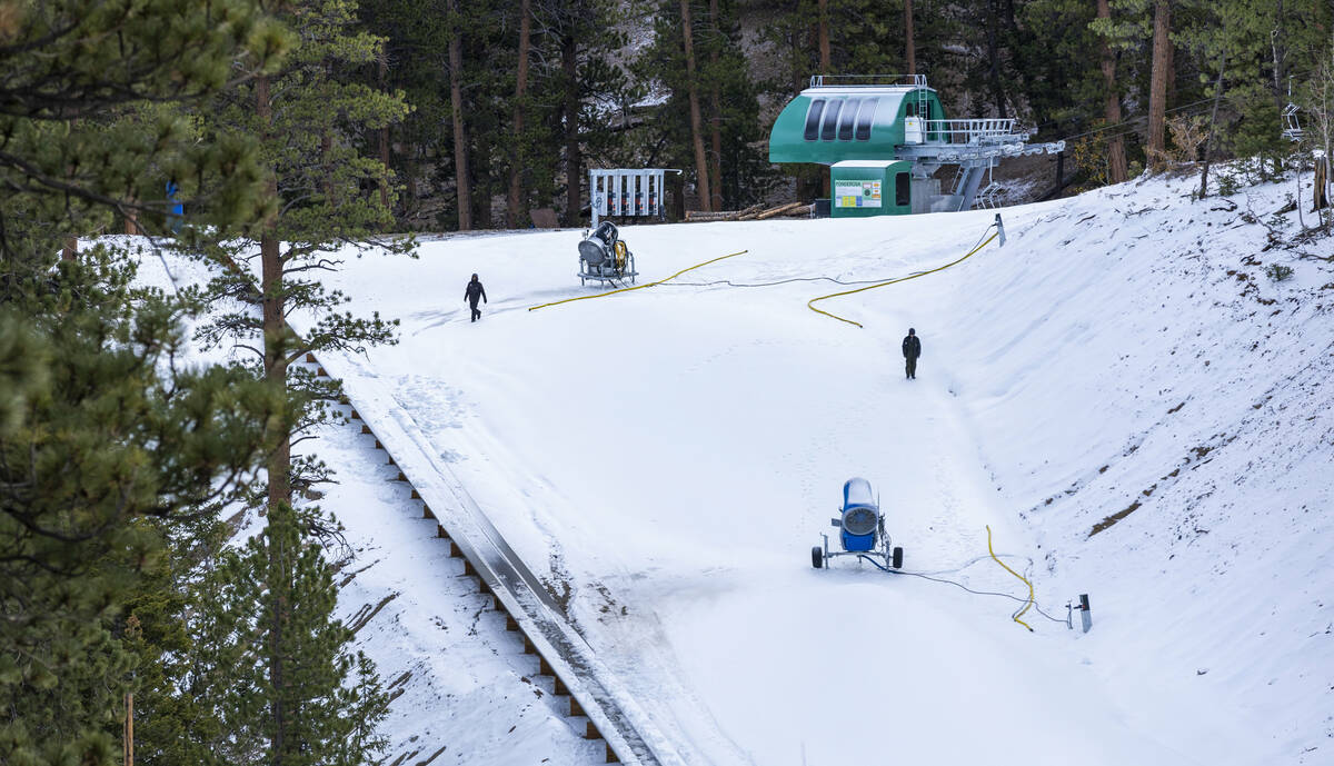 Operations staff walk along a slope as snow is beginning to be made at Lee Canyon on Thursday, ...