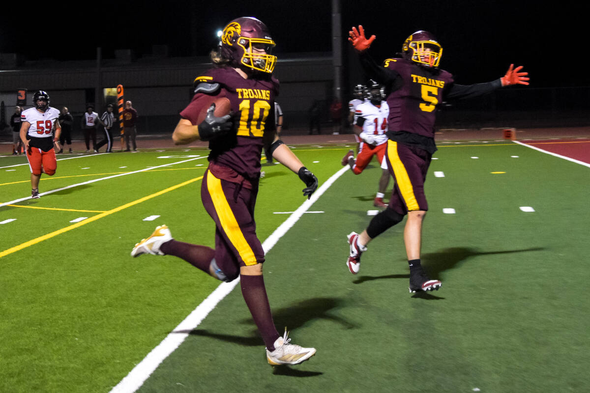 Trojans Randal Murray (10) walks the ball to the end zone after sneaking past Mater Academy Eas ...