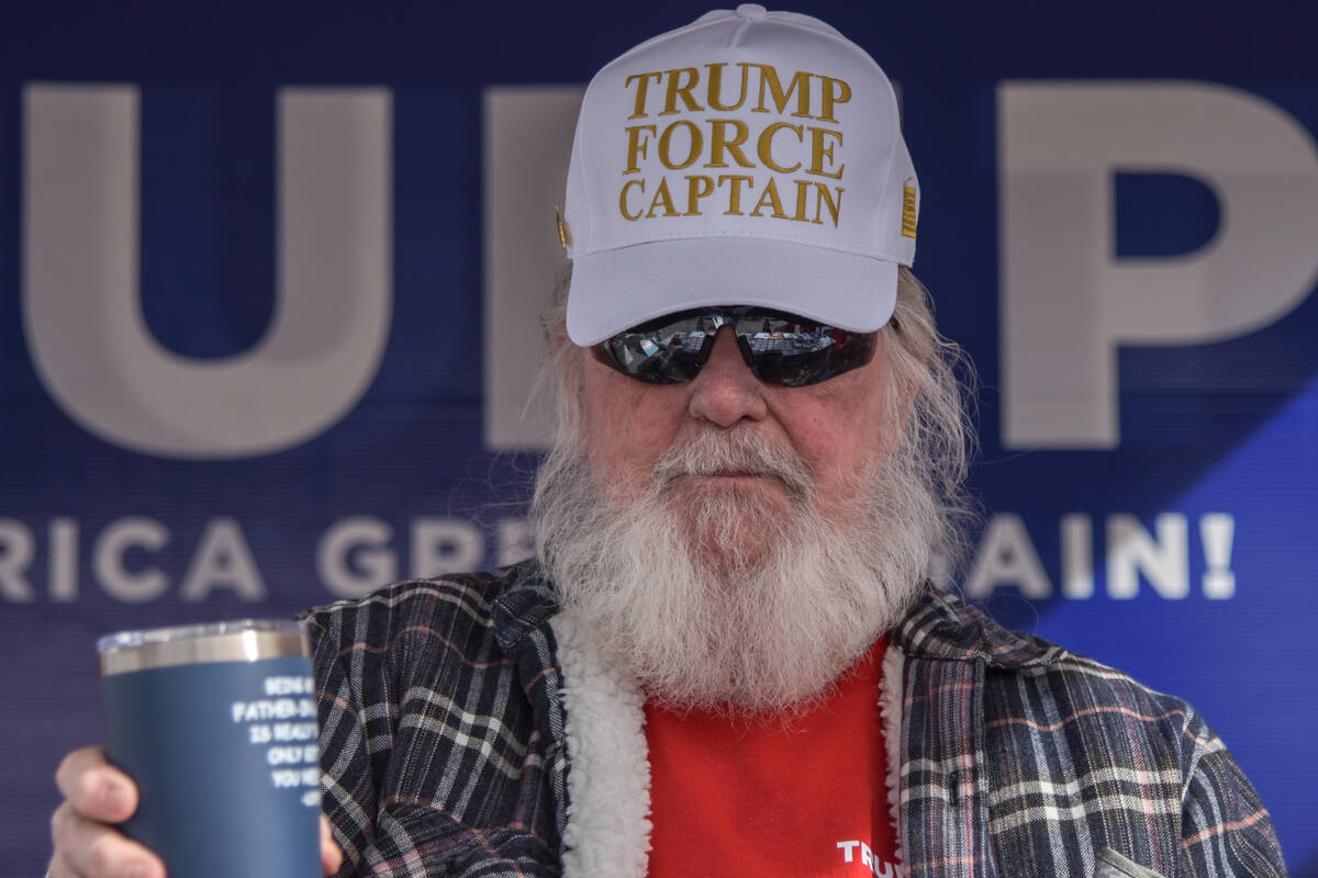 A man sports a "Trump Force Captain" hat in front of the Bob Ruud Community Center on Election ...