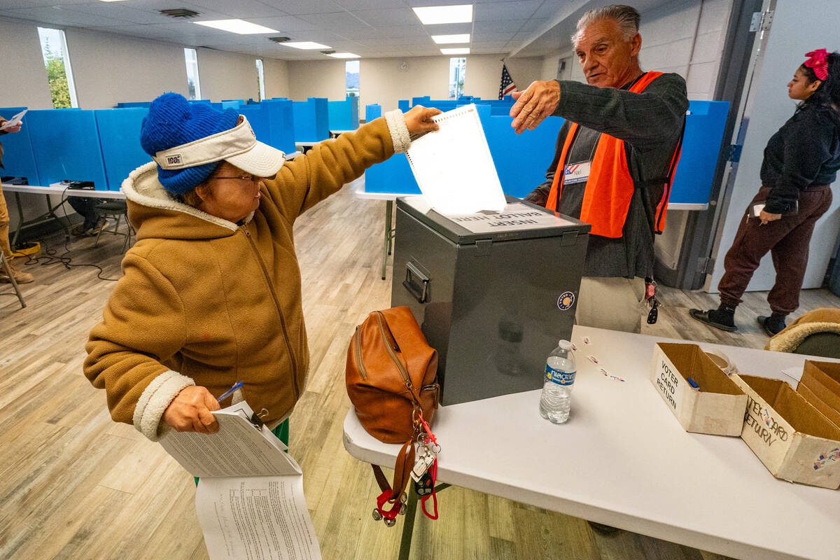 John Clausen/Pahrump Valley Times A Nye County voter submits her paper ballot at the Bob Rudd C ...