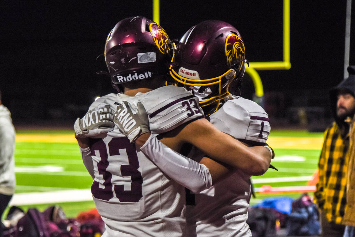 Trojans Austin Alvarez (33) (left) and Rhett Swaner (1) (right) hug after the season ends for P ...