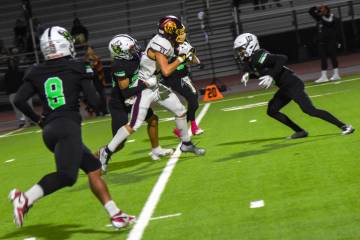 Pahrump Valley’s Austin Alvarez (33) runs the ball down the center against four SLAM pla ...