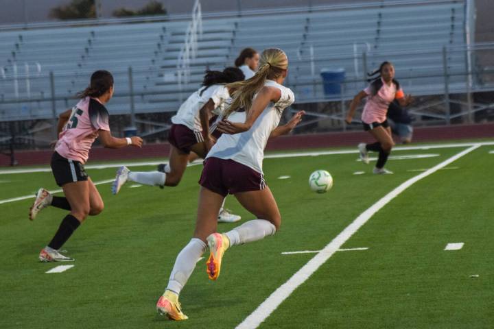 Trojans defenders run towards the ball as the Virgin Valley Bulldogs kick a long pass towards P ...