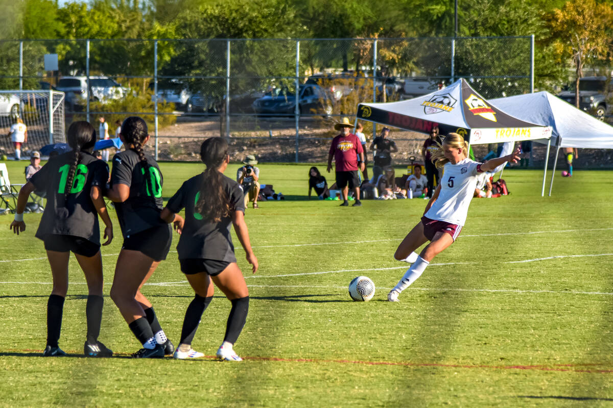 Pahrump Valley’s Khylarann Park (5) (right) kicks and scores a goal on the SLAM Bulls to ...