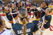 Pahrump Valley girls volleyball team huddles to listen to their coaches for their first game ag ...