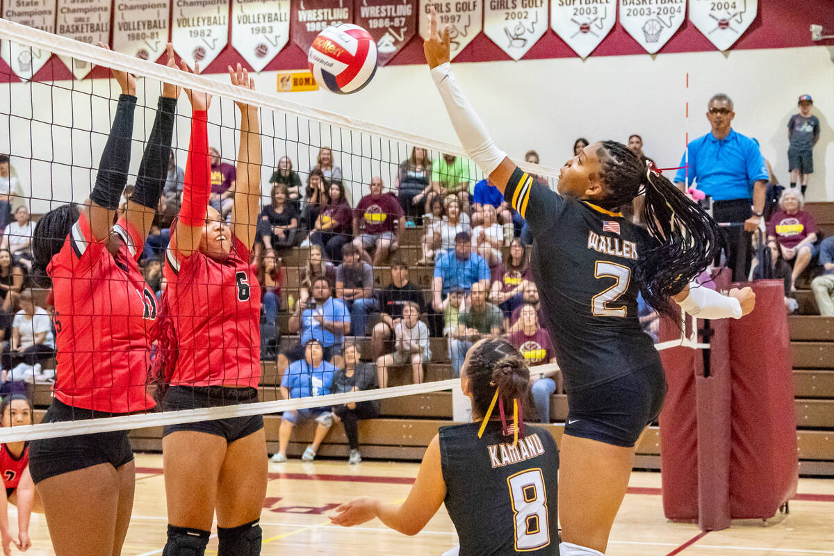 Pahrump Valley (right) Marayah Walley (2) hits the ball over the net over to the Mater Academy ...