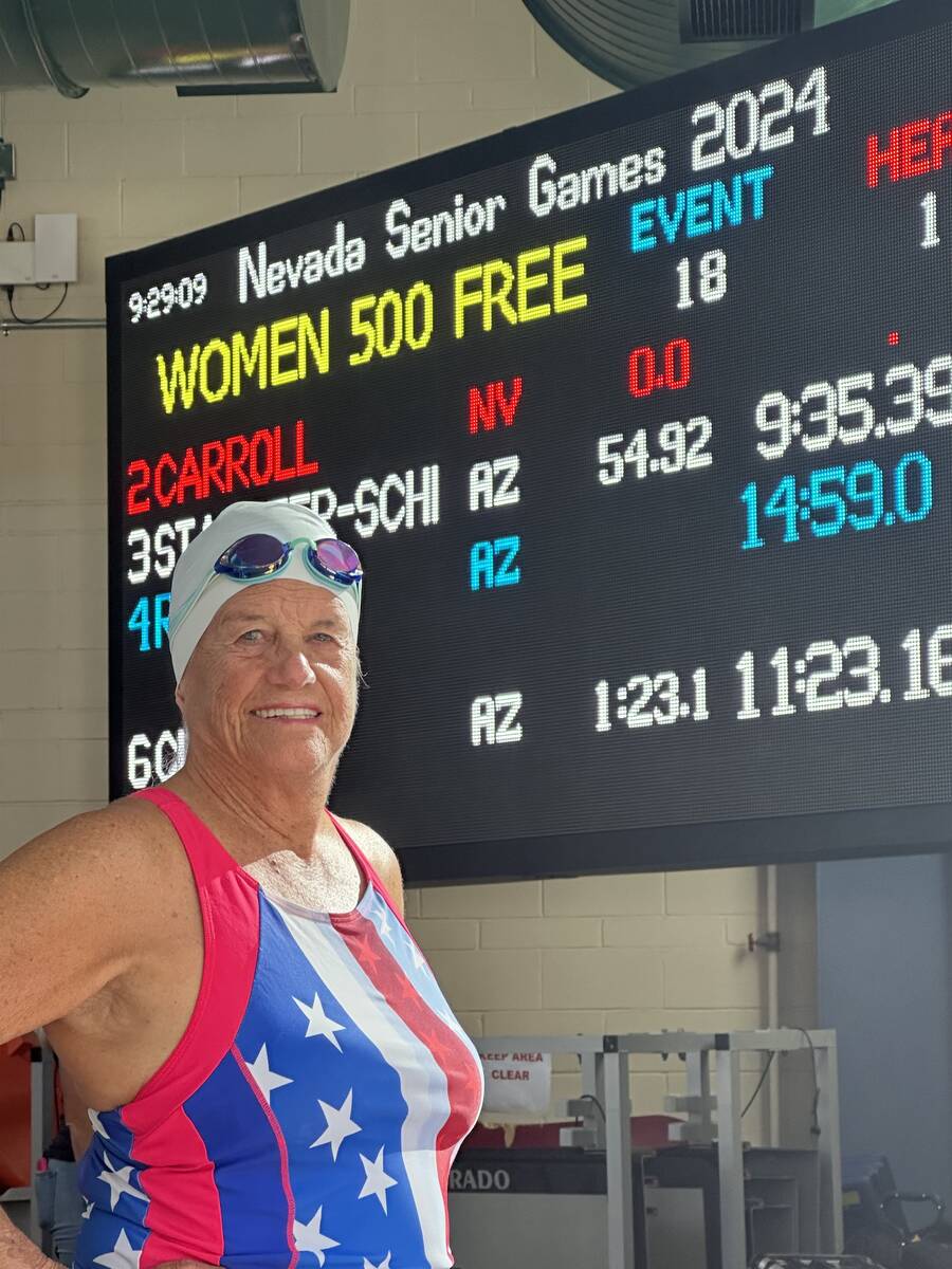 Cathy Behrens poses with the score board at the Nevada Senior Games where she received a gold m ...