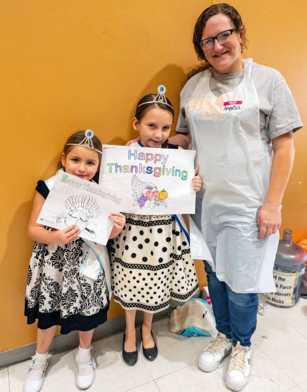 John Clausen/Pahrump Valley Times A Community Thanksgiving Dinner volunteer and her two youngst ...