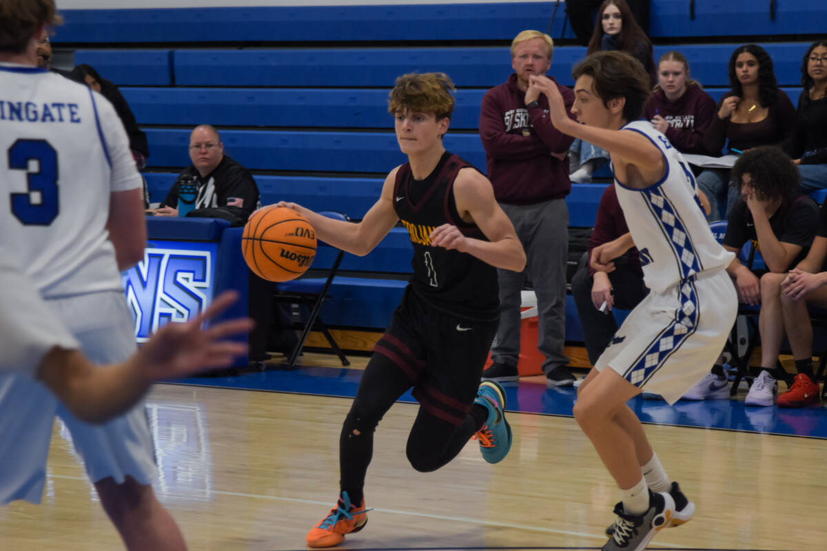 Trojan junior Keir Sheppard (1) attempts to get past Coral Academy on Friday, Dec. 6, in Hender ...