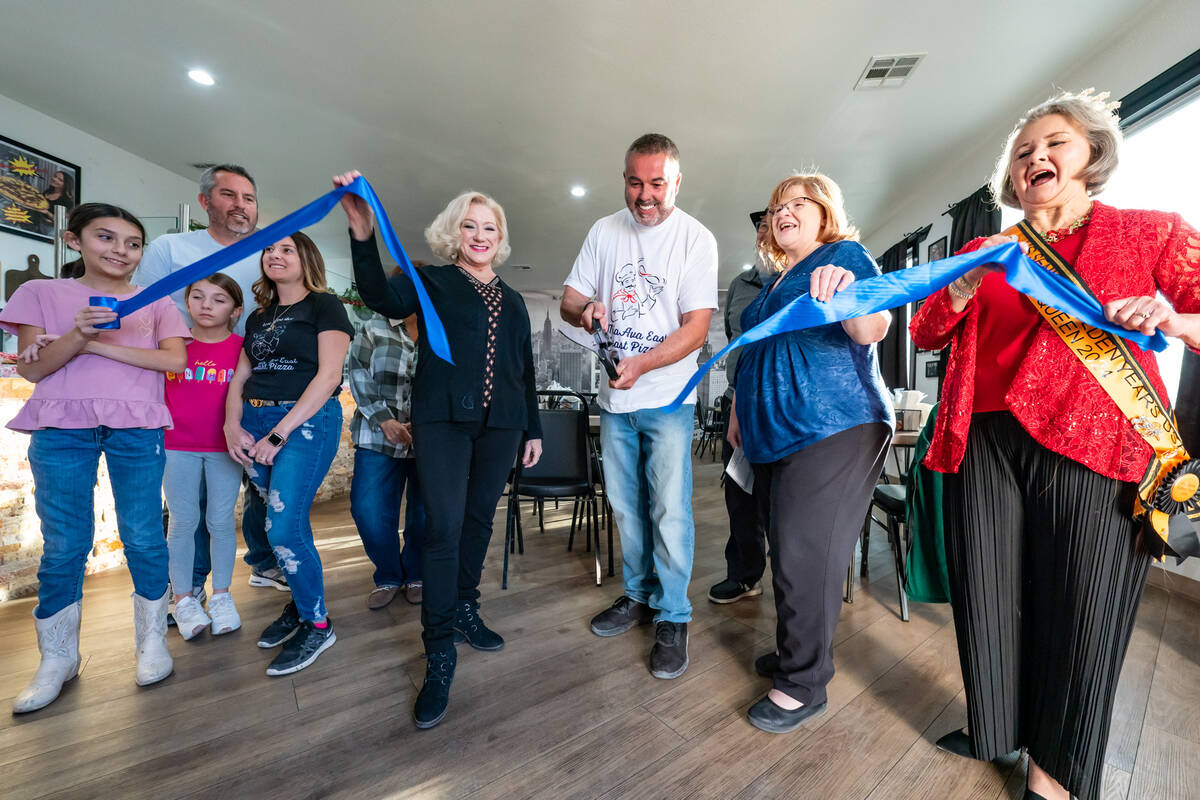 John Clausen/Pahrump Valley Times Owner Gary Rurans (center) cuts the ribbon inside Mia Ava Eas ...