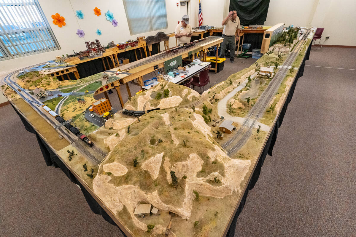 The train sets are mounted on plywood sheets for the display and the club formed hills, laid ra ...