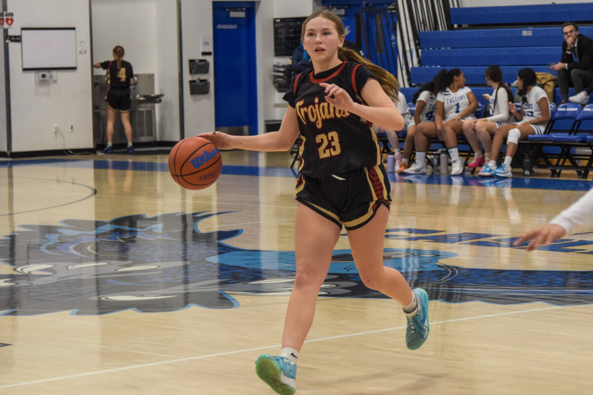 Trojans’ Nala Dalton (23) dribbles the ball towards the Coral Academy Falcons side of th ...