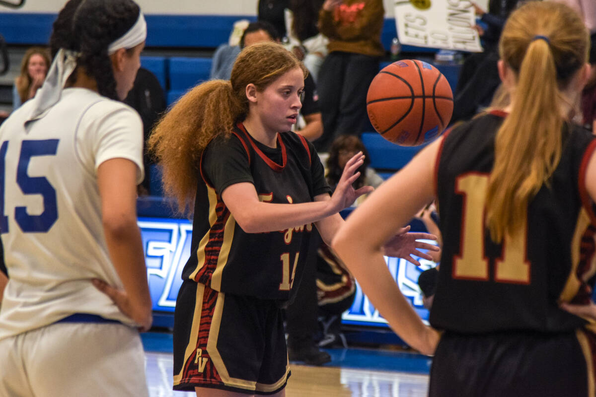 Trojans’ Trinity French (14) dribbles the ball before shooting her free-throws against t ...