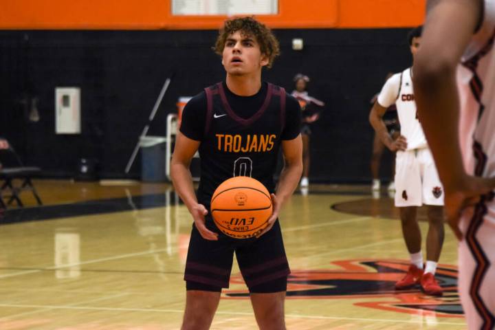 Trojans junior Alejandro Lozano (0) gets the ball before shooting free throws against the Chapa ...