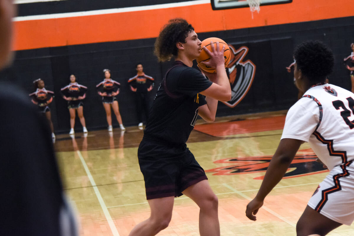 Trojans senior Antwahn Jackson (12) attempts to get the ball to one of his players while the Ch ...