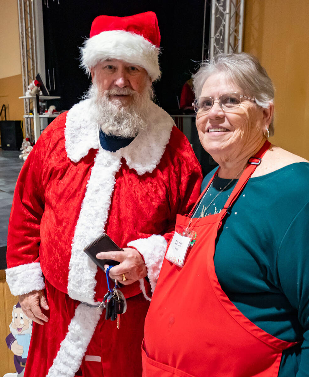 John Clausen/Pahrump Valley Times Pahrump Holiday Task Force leader Linda Wright, right, stops ...