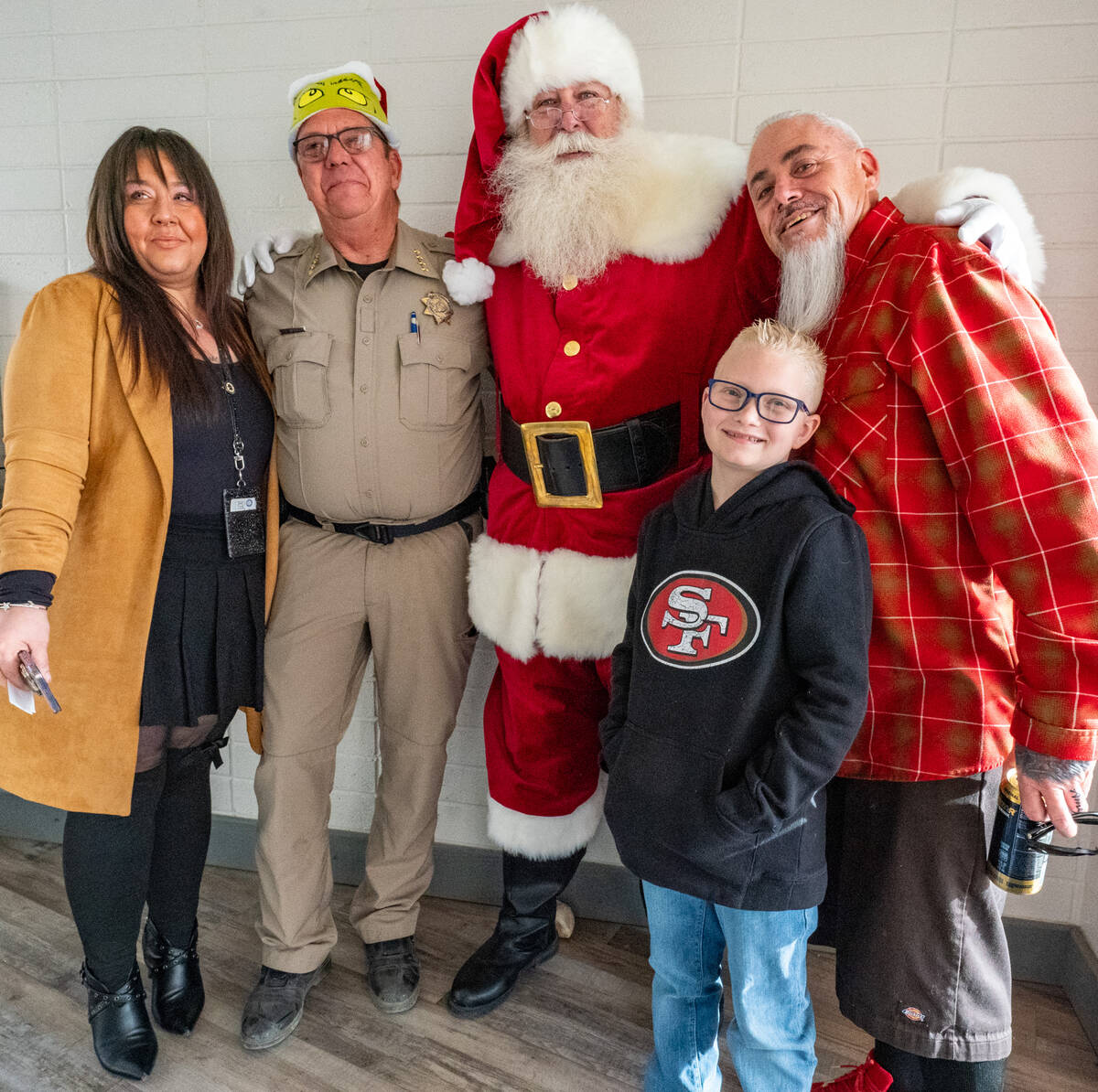 John Clausen/Pahrump Valley Times Annie Burcato of DCFS, NCSO Sheriff Joe McGill, Santa, Mom’ ...