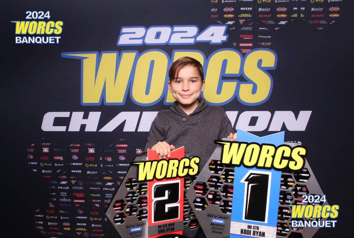 Kroi Ryan holds his first- and second-place trophies after racing in two different 90cc stock c ...