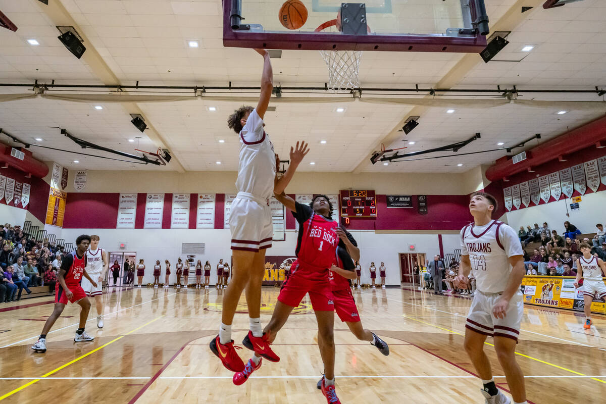 Trojans junior Aydon Veloz (11) (left) jumps to score a two points against the Doral Academy Dr ...