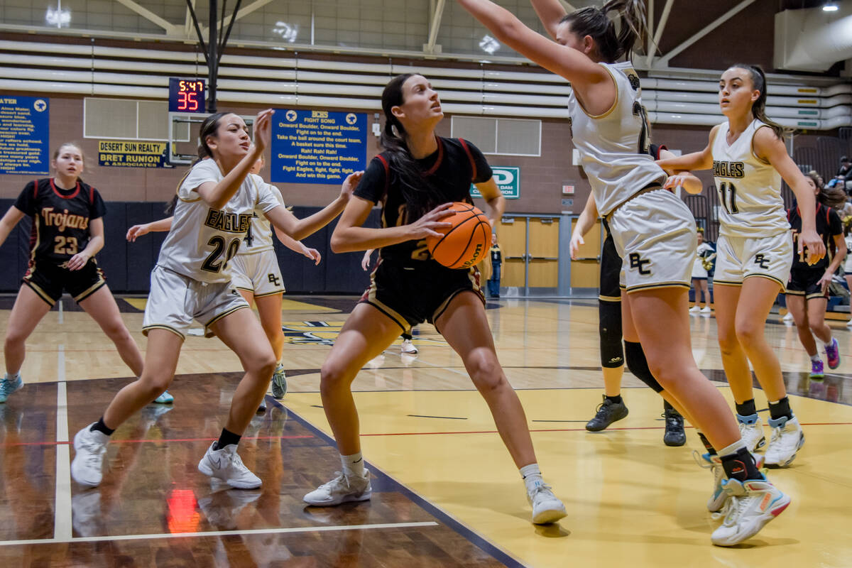 Trojans sophomore Riley Saldana attempts to find an opening to shoot the ball against Boulder C ...