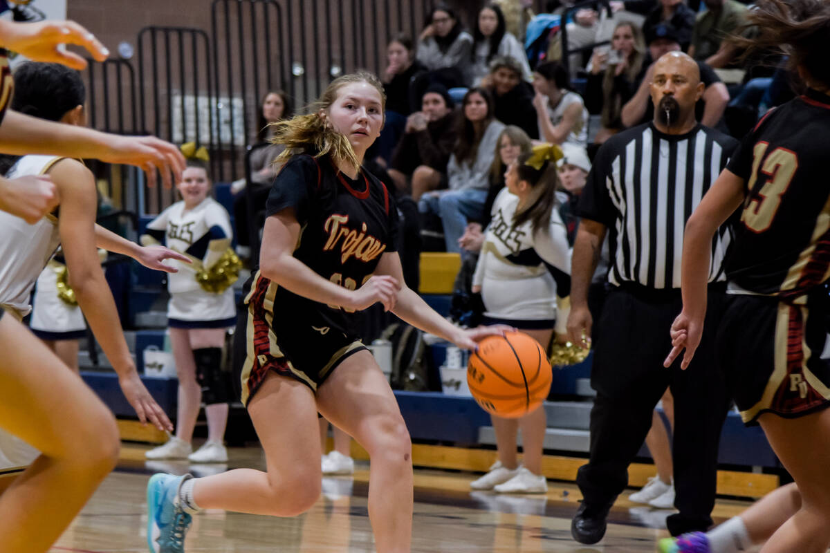 Trojans junior Nala Dalton (23) looks for an opening to pass the pass against Boulder City in a ...