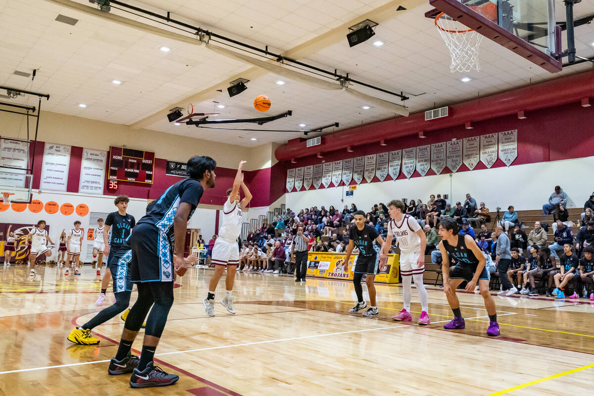 Trojans junior Joshua Slusher (14) (center) takes his free-throws against Pinecrest Academy Slo ...