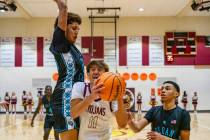 Trojans junior Aydon Veloz (11) is being blocked from the Pinecrest Academy Sloan Canyon defens ...