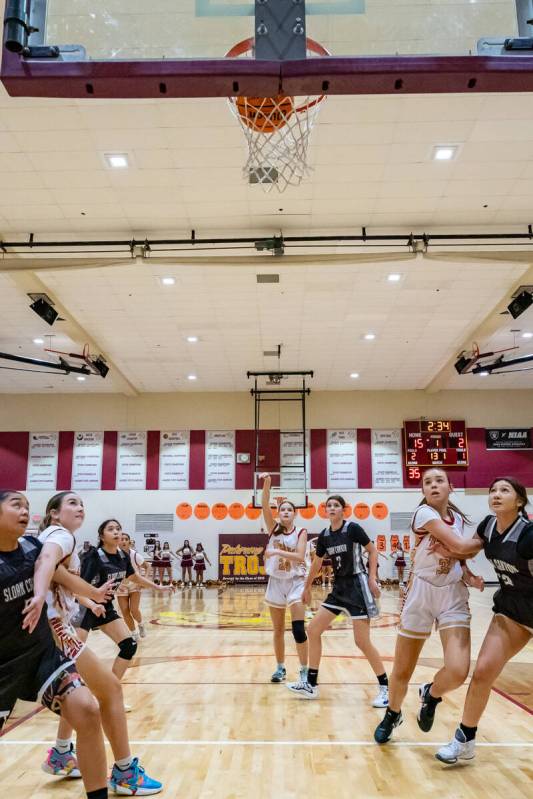 Trojans' freshman Ella Odegard (24) (center) shoots her free-throw shots against Pinecrest Acad ...