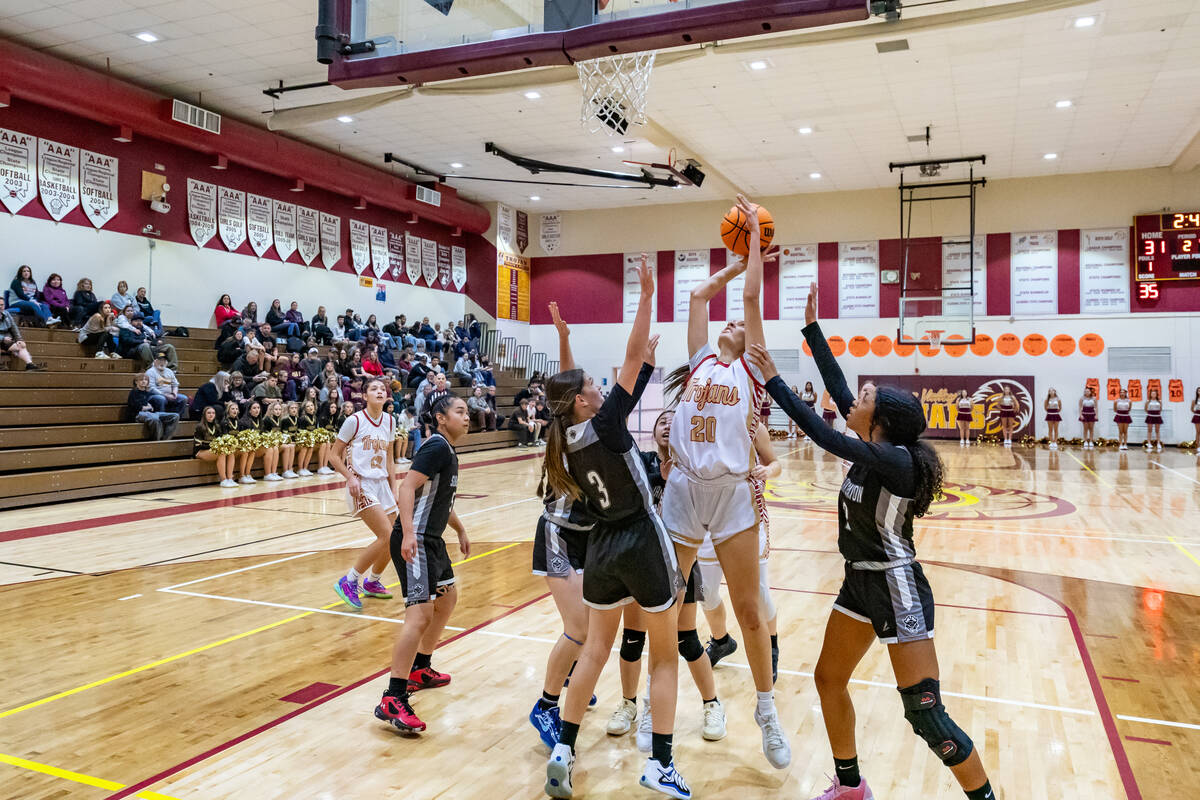 Trojans' sophomore Riley Saldana (20) (center) attempts to score against Pinecrest Academy Sloa ...