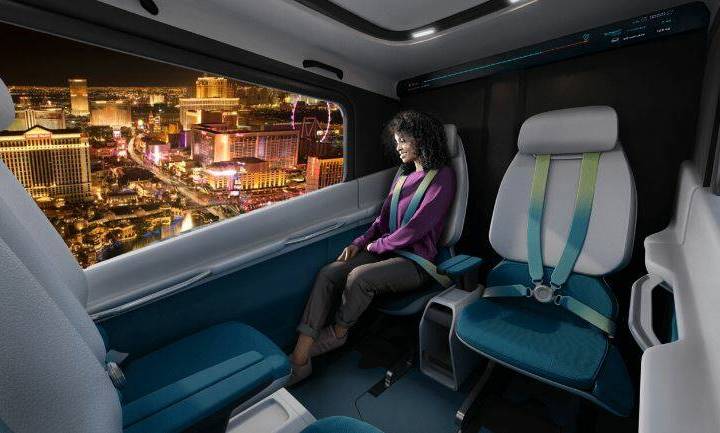 A rendering of a passenger using an air taxi aircraft in the skies over Las Vegas. (Courtesy La ...