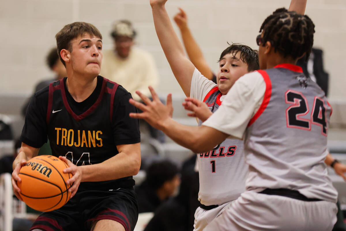 Pahrump Valley guard Joshua Slusher (14) eyes an open teammate during a basketball game between ...