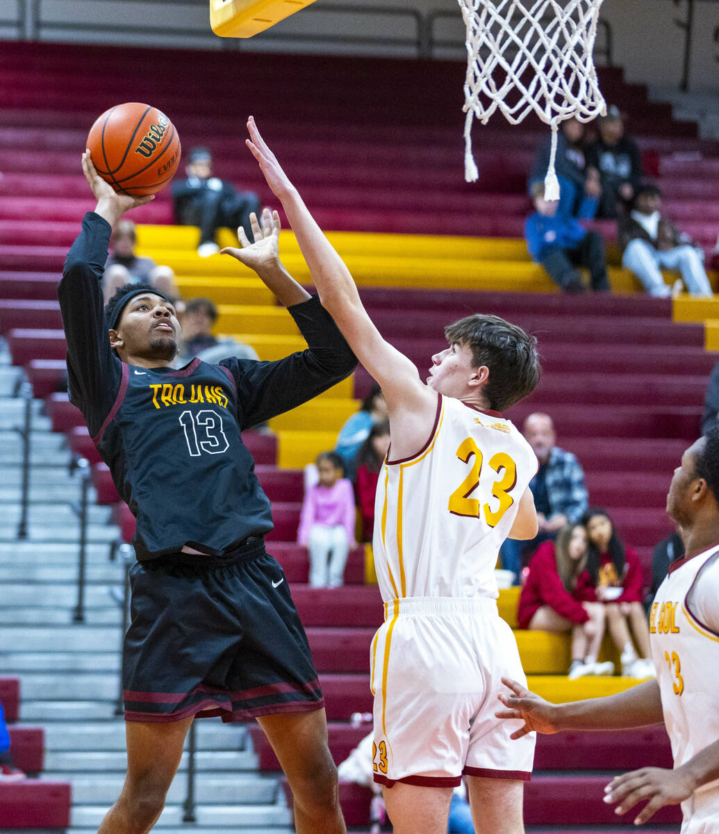 Pahrump Valley forward Tramaine Burras (13) posts up for a shot over Del Sol center William Phi ...