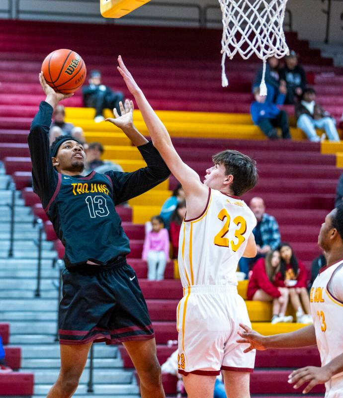 Pahrump Valley forward Tramaine Burras (13) posts up for a shot over Del Sol center William Phi ...