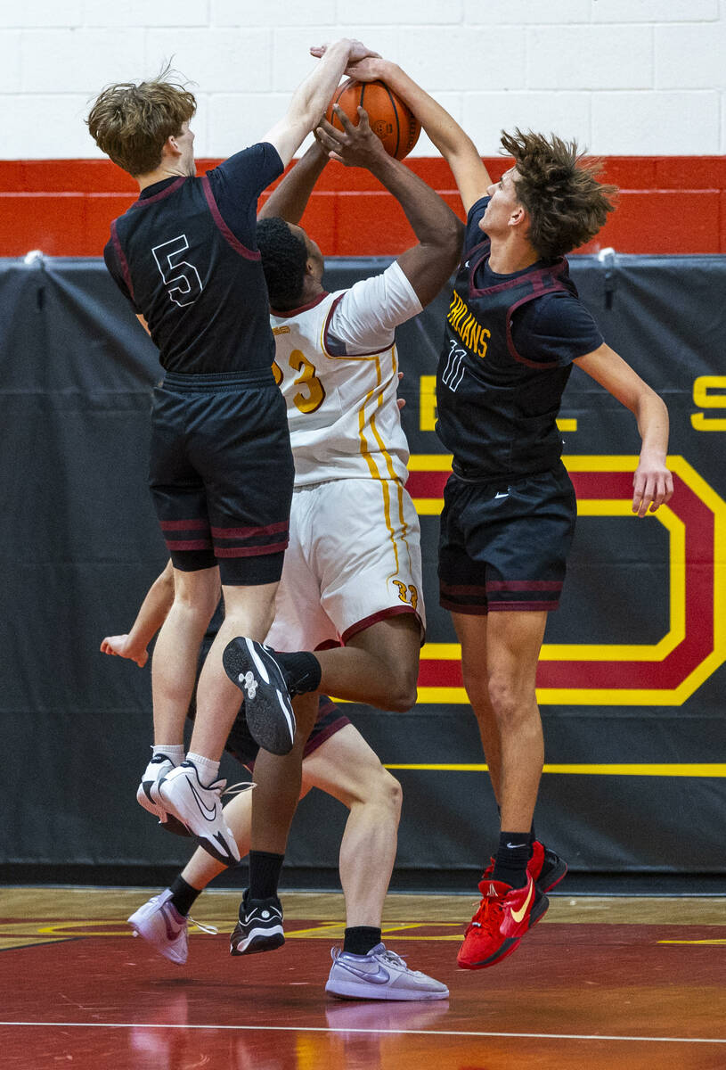 Pahrump Valley guard Jack Toth (5) and teammate forward Aydon Veloz (11) team up to block a sho ...