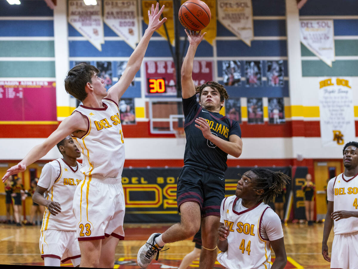 Pahrump Valley guard Alejandro Lozano (0) shoots past Del Sol center William Philips (23) with ...