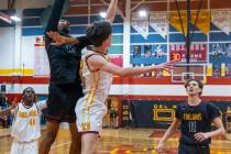 Pahrump Valley forward Tramaine Burras (13) shots over Del Sol center William Philips (23) as f ...