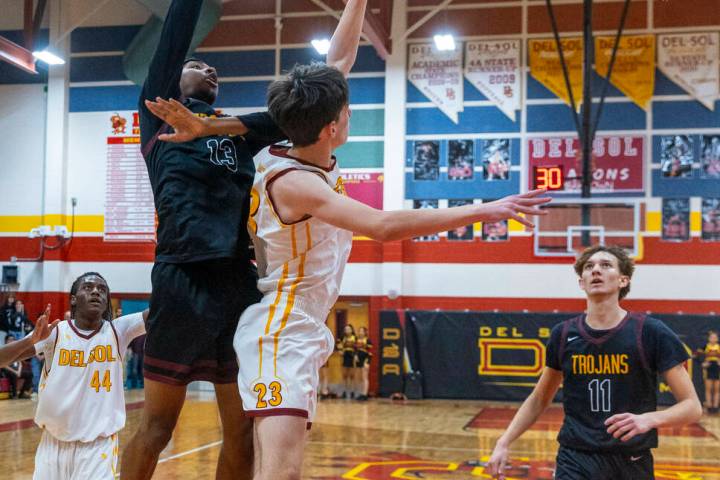 Pahrump Valley forward Tramaine Burras (13) shots over Del Sol center William Philips (23) as f ...