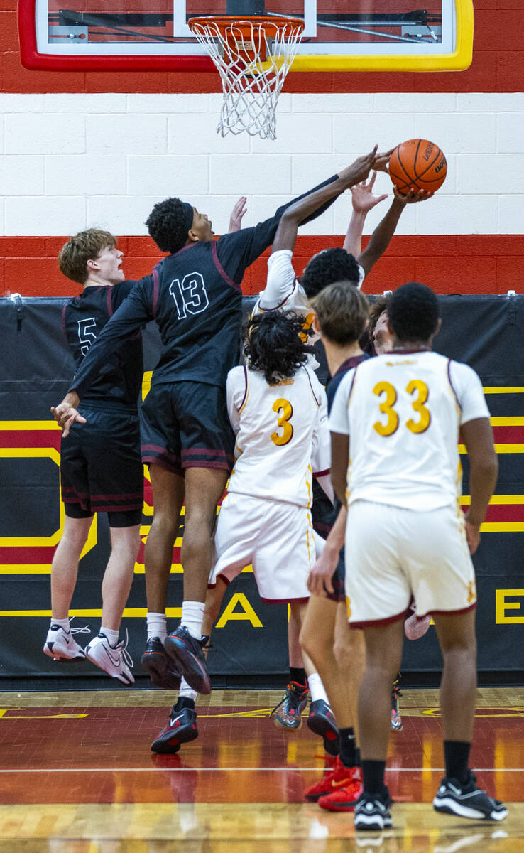 Pahrump Valley forward Tramaine Burras (13) with guard Jack Toth (5) rejects a shot by Del Sol ...