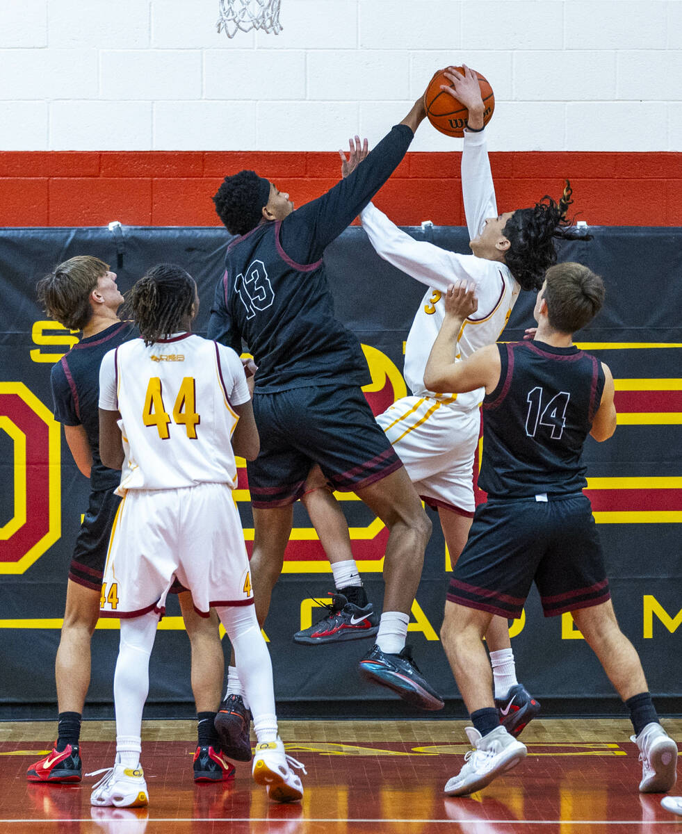 Pahrump Valley forward Tramaine Burras (13) rejects a shot by Del Sol guard Raymond Orozco Guev ...