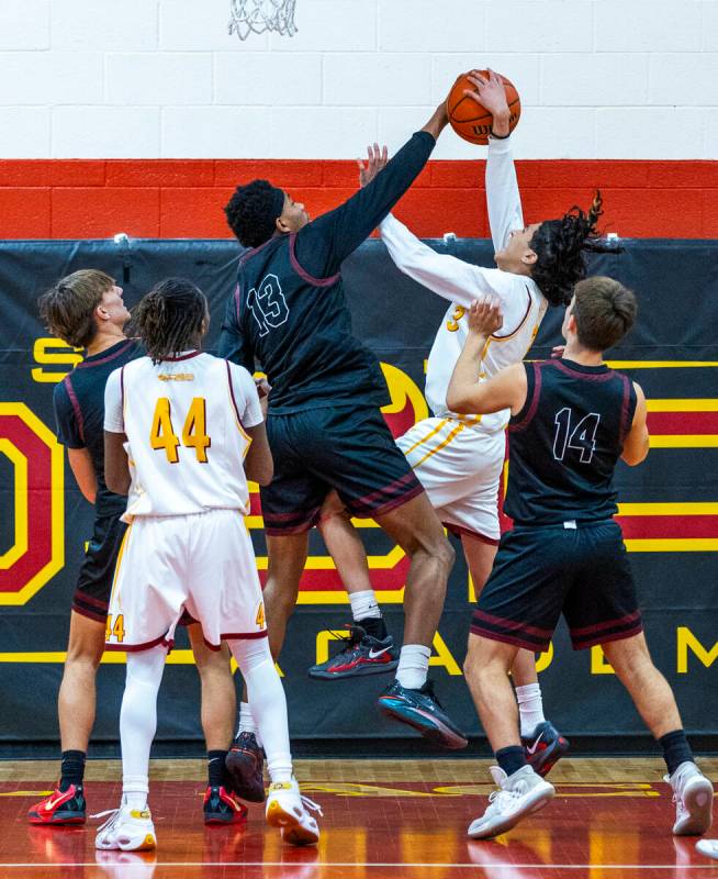 Pahrump Valley forward Tramaine Burras (13) rejects a shot by Del Sol guard Raymond Orozco Guev ...