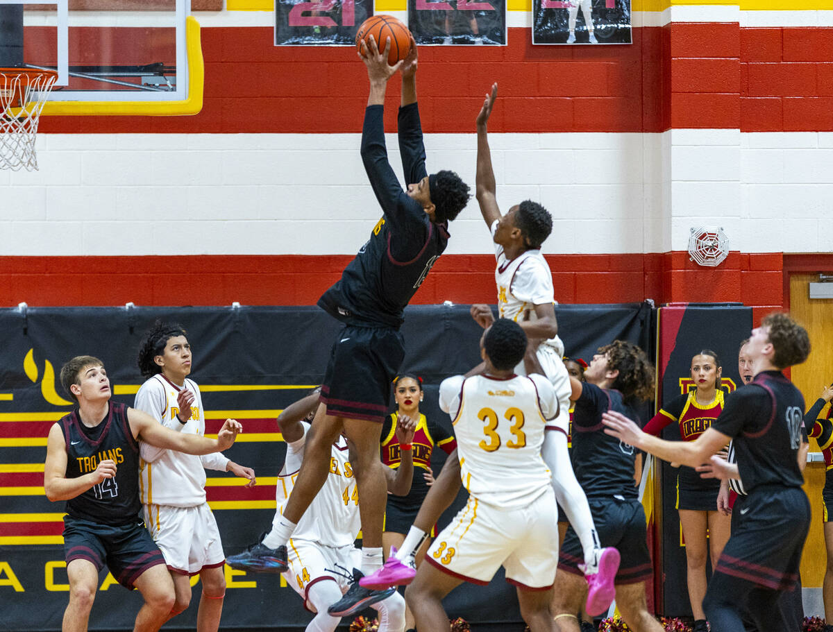 Pahrump Valley forward Tramaine Burras (13) pulls down a rebound in front of Del Sol guard Jaed ...