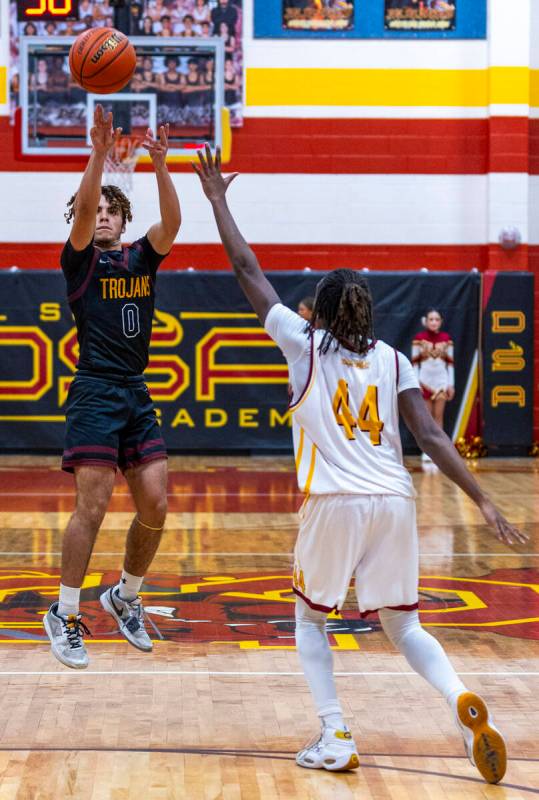 Pahrump Valley guard Alejandro Lozano (0) elevates for a shot past Del Sol forward Ameer Willia ...