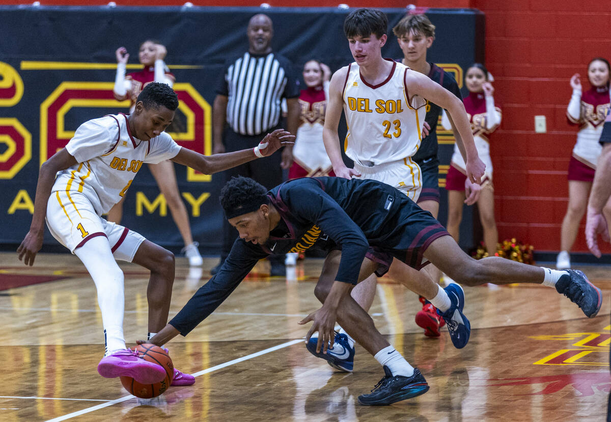 Pahrump Valley forward Tramaine Burras (13) grabs a loose ball at the feet of Del Sol guard Jae ...