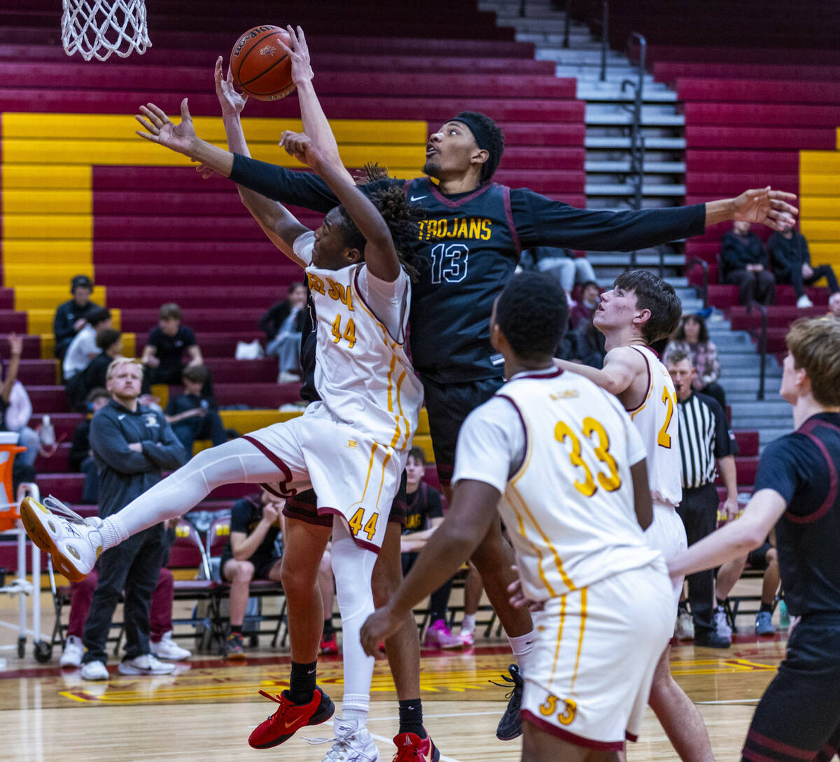 Pahrump Valley forward Tramaine Burras (13) works to steal a rebound from Del Sol forward Ameer ...