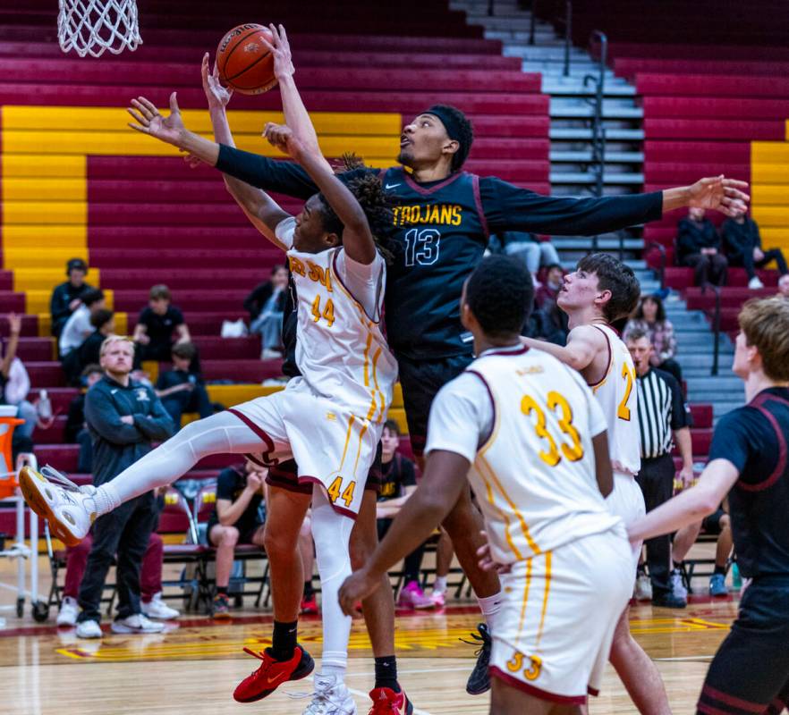 Pahrump Valley forward Tramaine Burras (13) works to steal a rebound from Del Sol forward Ameer ...