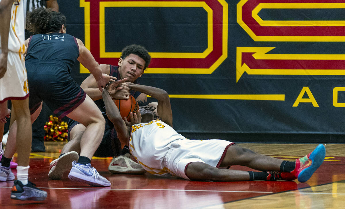 Pahrump Valley forward Jamiah Mendenhall (23) fights for a loose ball on the floor with Del Sol ...